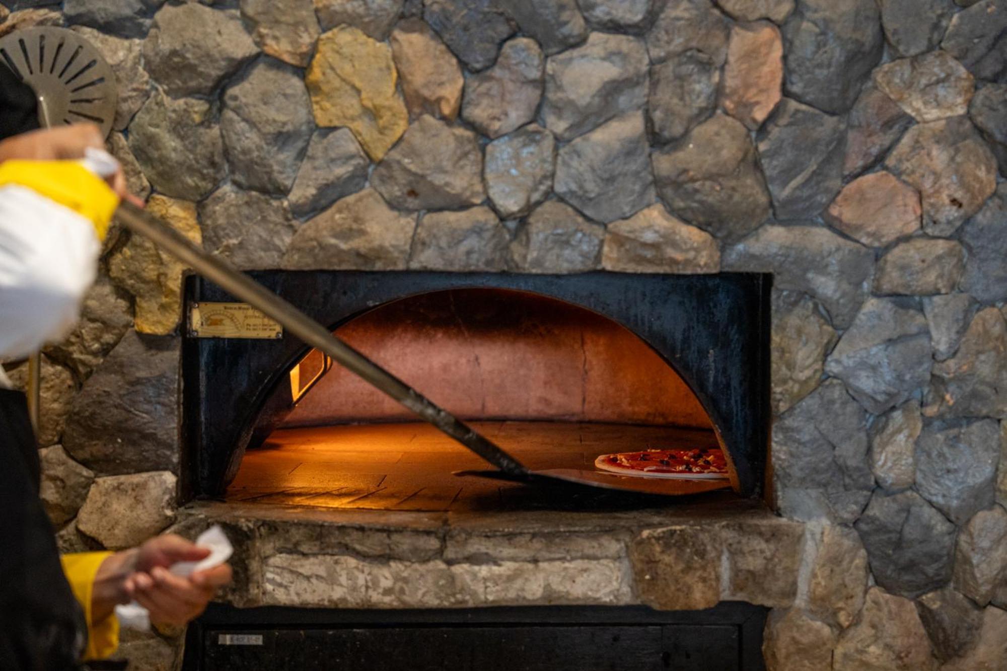 Dusit Thani Krabi Beach Resort - Sha Extra Plus Klong Muang Beach Esterno foto A pizza being removed from a wood-fired oven